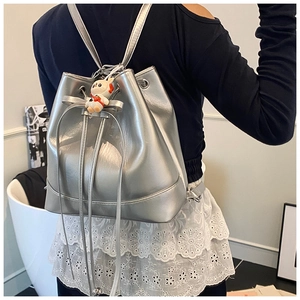 Silver metallic drawstring bucket backpack featuring a cute white rabbit plush keychain
