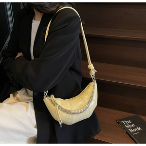 Chic light yellow croissant bag with quilted leather and decorative pearl chain detail