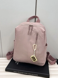 Pink minimalist nylon backpack with front zipper and yellow charm for women