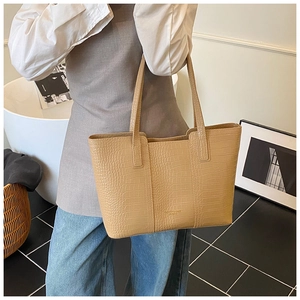 Close-up of beige crocodile pattern tote bag showing high-quality PU leather and shoulder strap