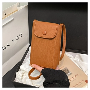 Detail of a brown lychee pattern leather mobile crossbody bag with a front card pocket