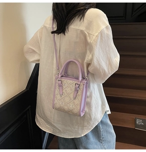 Détail d'un sac bandoulière bohème lilas avec motif floral porté par un mannequin