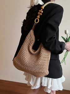Woven crochet shoulder bag with wooden beads and ring details for beach holidays