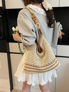 Bohemian hand-woven tote bag with beaded shoulder strap and neutral striped details