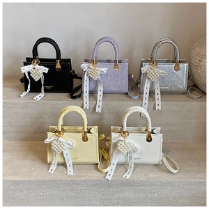 Detailed display of mini crossbody bags in five colors with pearl heart charms