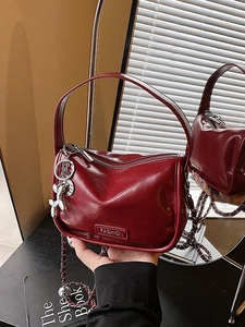 Luxury wine red glossy crossbody bag with metal chain strap and cute balloon dog charm