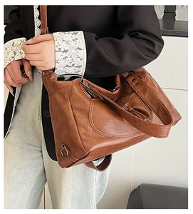 Retro brown tote bag made of glossy leather material shown on a model for daily commute