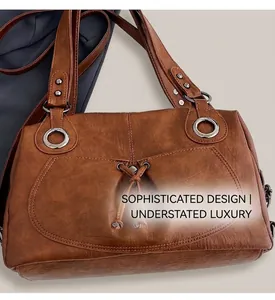 Detail of caramel tote bag with lychee texture, bow tie strap and silver metal ring