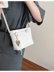 White litchi pattern bucket bag with silver buckle and heart pendant for daily commute