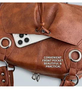 Detail shot of the front pocket of a vintage dark brown leather tote with a smartphone