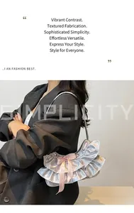 Detail of silver metallic shoulder bag with ruffle layers and pink satin bow accent