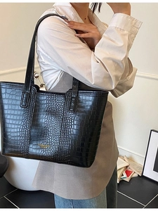 Minimalist black crocodile pattern tote bag for women with gold lettering and long straps