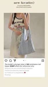 Close-up of light blue striped nylon hobo bag featuring a white lace bow charm detail