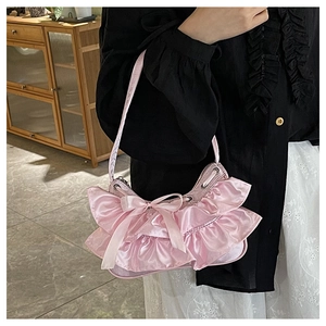 Close-up of pink satin hobo bag with tiered ruffles and decorative ribbon bow details