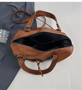 Interior view of large brown vintage tote bag showing spacious storage and zipper pocket