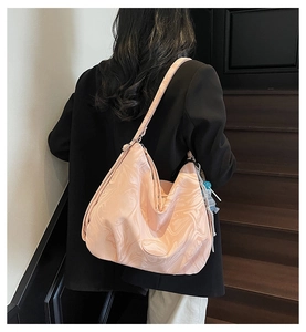 Detail of pink marble pattern tote bag with teddy bear charm and soft pleated design