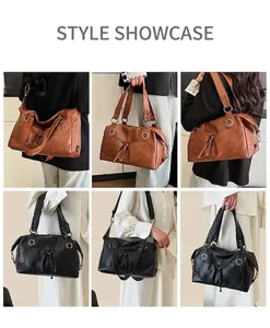 Detail view of retro textured leather tote bags in black and brown with metal ring accents