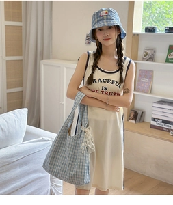 Detail of light blue plaid tote bag with white lace trim and matching bucket hat