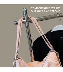 Detail of soft pink marble tote bag featuring sturdy shoulder strap and silver hardware