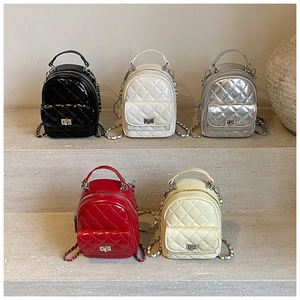 Five mini quilted backpacks in diverse colors featuring diamond patterns and chain straps