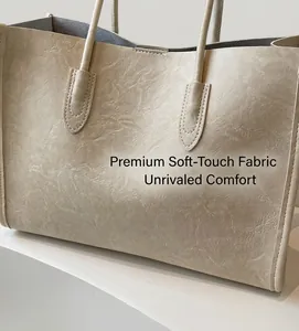 Close-up of the beige tote bag featuring soft pleated PU leather and refined texture