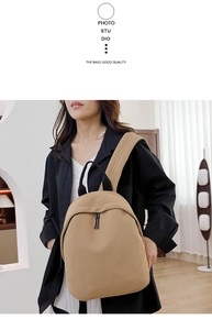 Detailed view of light brown Oxford fabric backpack with woven texture on a model