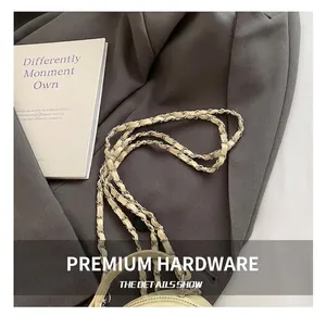 Detail of silver chain strap interwoven with beige leather on a stylish backpack