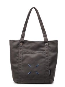 Minimalist large canvas tote bag in dark gray with signature blue stitching and metal snaps