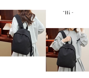 Minimalist black Oxford cloth backpack for women with adjustable straps and top handle