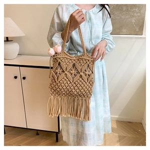 Detailed view of woven tote bag with intricate diamond mesh patterns and long tassels