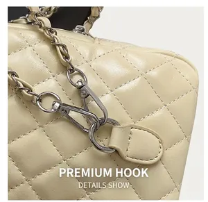 Detailed close-up of premium silver metal hooks and quilted leather chain on beige bag