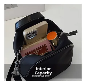 Detail view of the interior capacity showing a smartphone and makeup items inside the bag