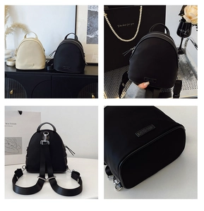 Detail view of stylish shell backpacks in black and beige with durable nylon finish