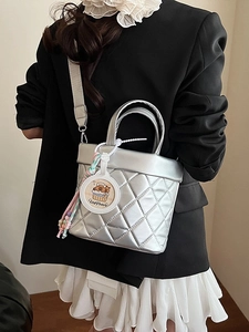 Silver quilted bucket bag with crossbody strap and Capybara charm for women