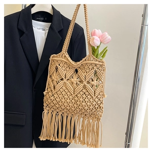Detail of bohemian woven tote bag with fringe tassels and diamond pattern texture