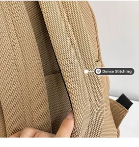 Detail view of precision stitching on a breathable mesh yellow Oxford backpack strap