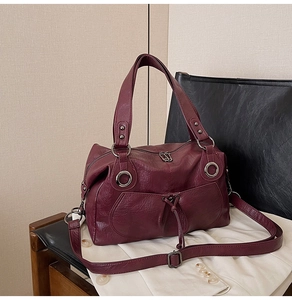 Close-up of wine red tote bag featuring lychee grain texture and silver hardware details