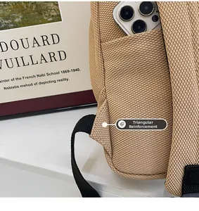 Macro detail of the backpack showing breathable mesh, reinforced seams, and hidden pocket