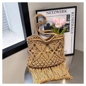 Detail of bohemian hand-woven tote bag showing intricate diamond patterns and long tassels