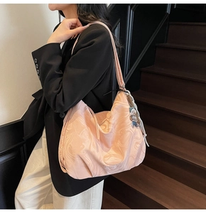 Pink marble pattern tote bag close-up with cute bear charm and soft leather texture details