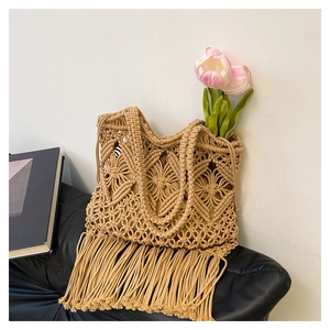 Detailed view of handmade camel macrame tote bag with intricate patterns and long tassels
