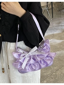 Lavender satin ruffled shoulder bag with white bow accent and feminine pleated design