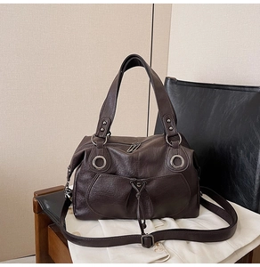 Close-up of vintage brown tote bag with drawstring pocket and silver ring detail