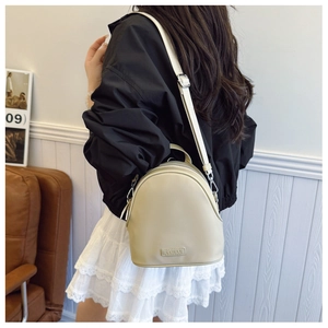Close-up of beige shell-shaped backpack showing fine PU leather texture and C&HEKA logo