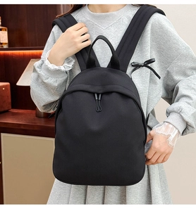 Detail view of black oxford backpack showing breathable honeycomb mesh and drawstring cord