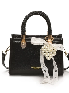 Chic black pleated handbag with pearl heart charm and lace bow on white background