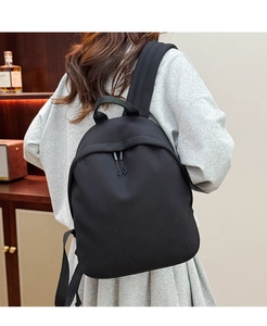 Close-up of black breathable mesh oxford backpack with durable double zipper detail