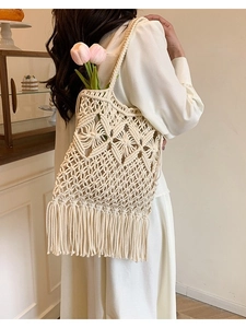 Chic cream woven shoulder bag with hollow mesh pattern and long decorative fringe