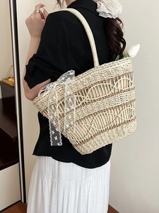 Fashionable straw tote bag for women with lace bow and brown wave pattern accents