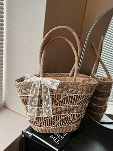 Handwoven straw tote bag with elegant white lace bow and wavy texture for summer style